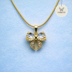 Crystal bow pendant necklace with gold chain