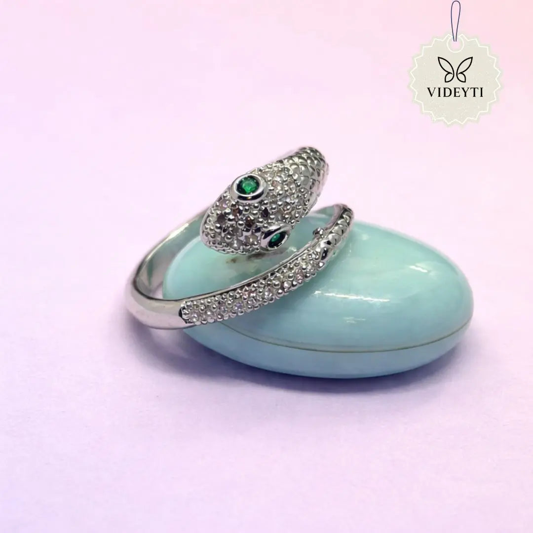Silver stainless steel snake wrap ring with pavé crystals and green gemstone eye; adjustable and anti-tarnish design