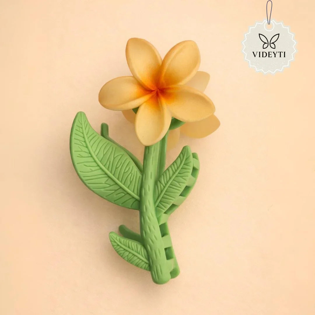 Orange flower stem hair clip with green leaves