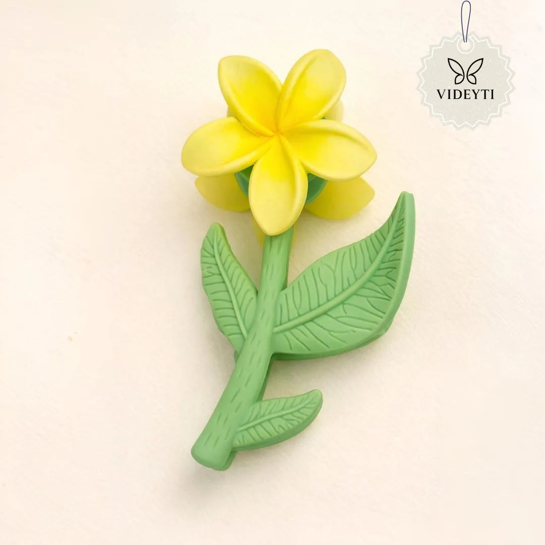 Yellow flower stem hair clip with green leaves