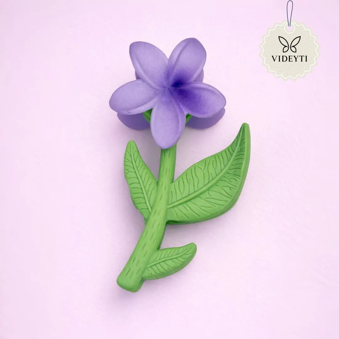 Purple flower stem hair clip with green leaves