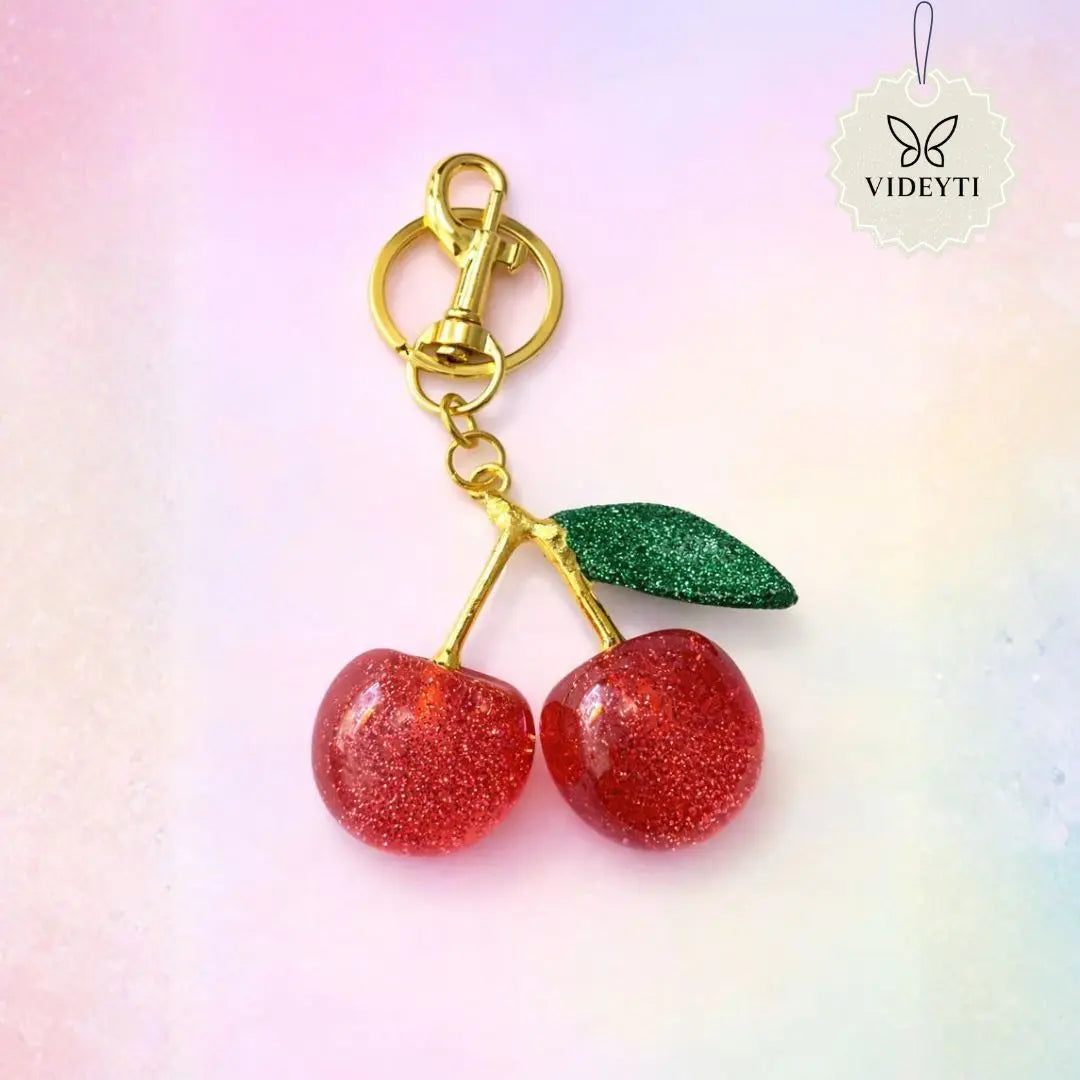 Rhinestone red cherry keychain with gold clasp and green crystal leaf