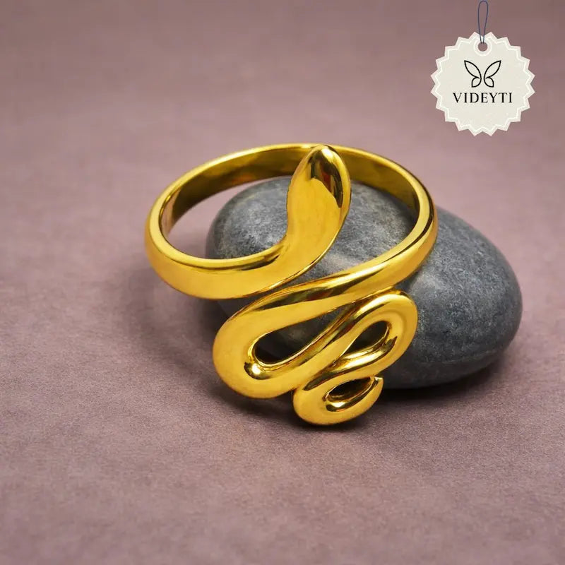 Gold snake-shaped adjustable ring made of stainless steel with a smooth curved design and polished finish.