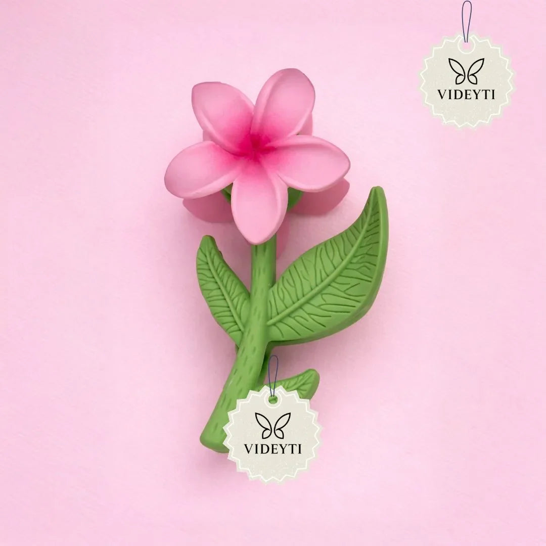 Pink flower stem hair clip with green leaves