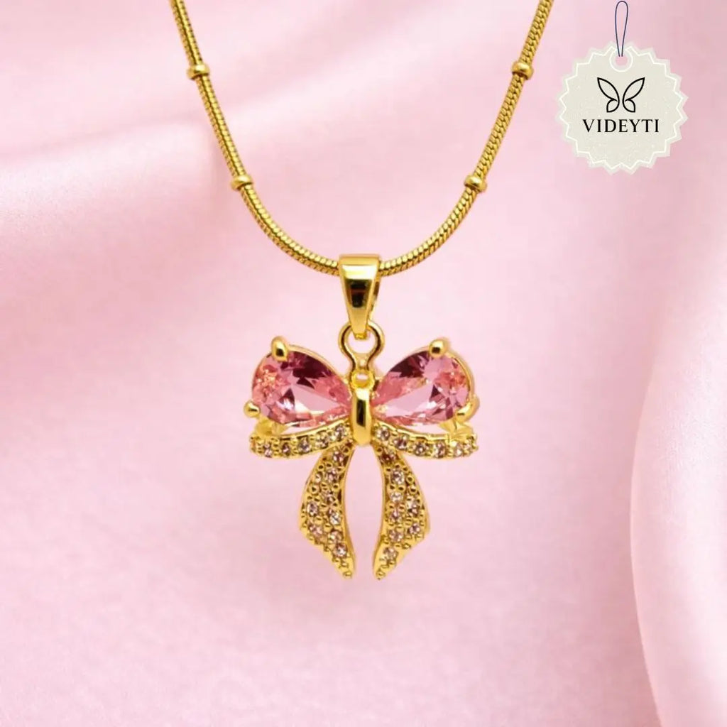 Pink bow pendant necklace with gold chain included