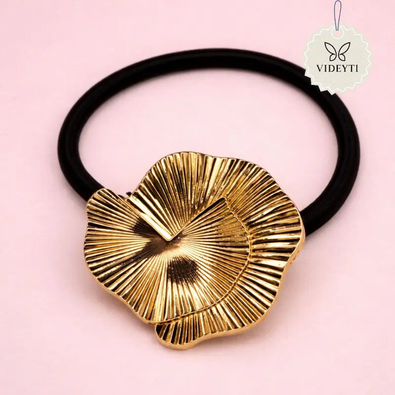 Black elastic hair tie with gold flower charm