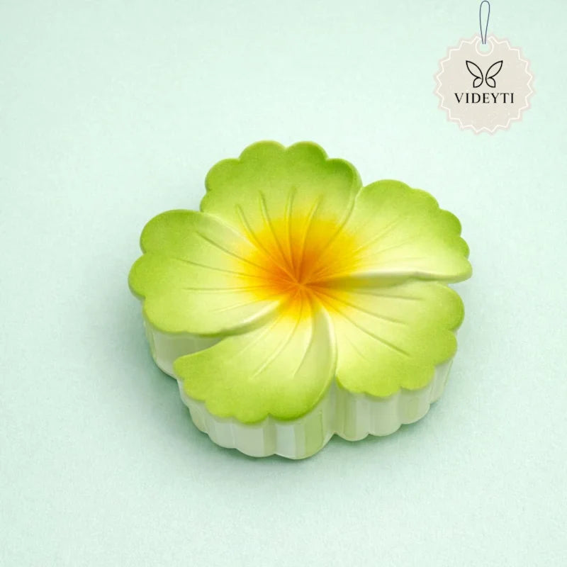 Green flower hair claw clip with yellow center