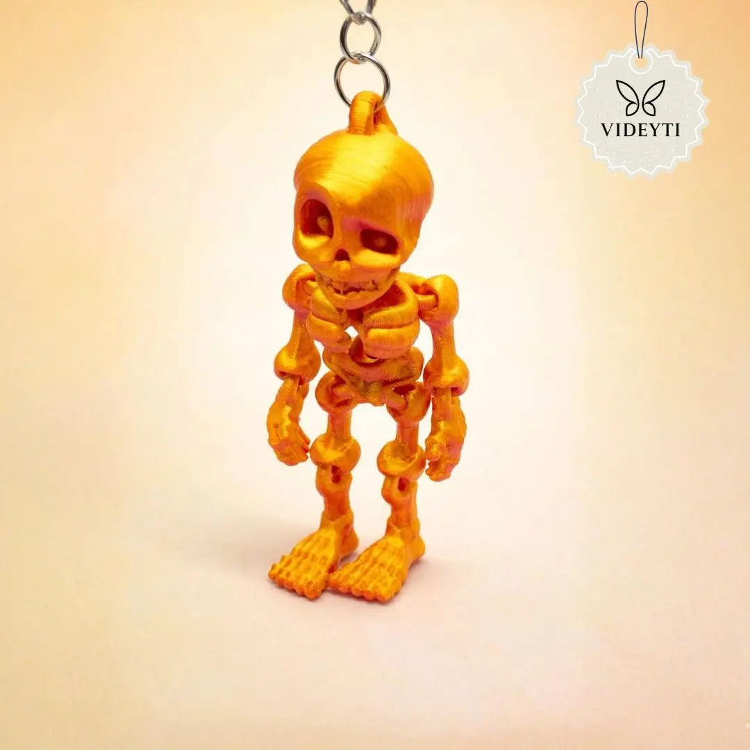 Orange resin skeleton figure keychain with metal chain
