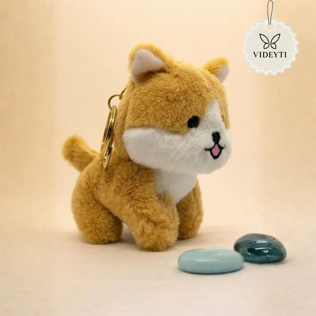 Cute plush dog bag charm in brown Shiba style with white details and gold keychain ring.