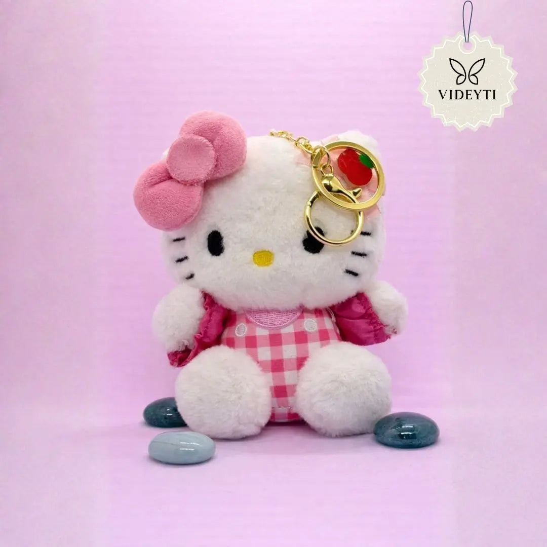 Plush kitty bag charm with pink bow and pink gingham outfit holding a gold keychain ring.