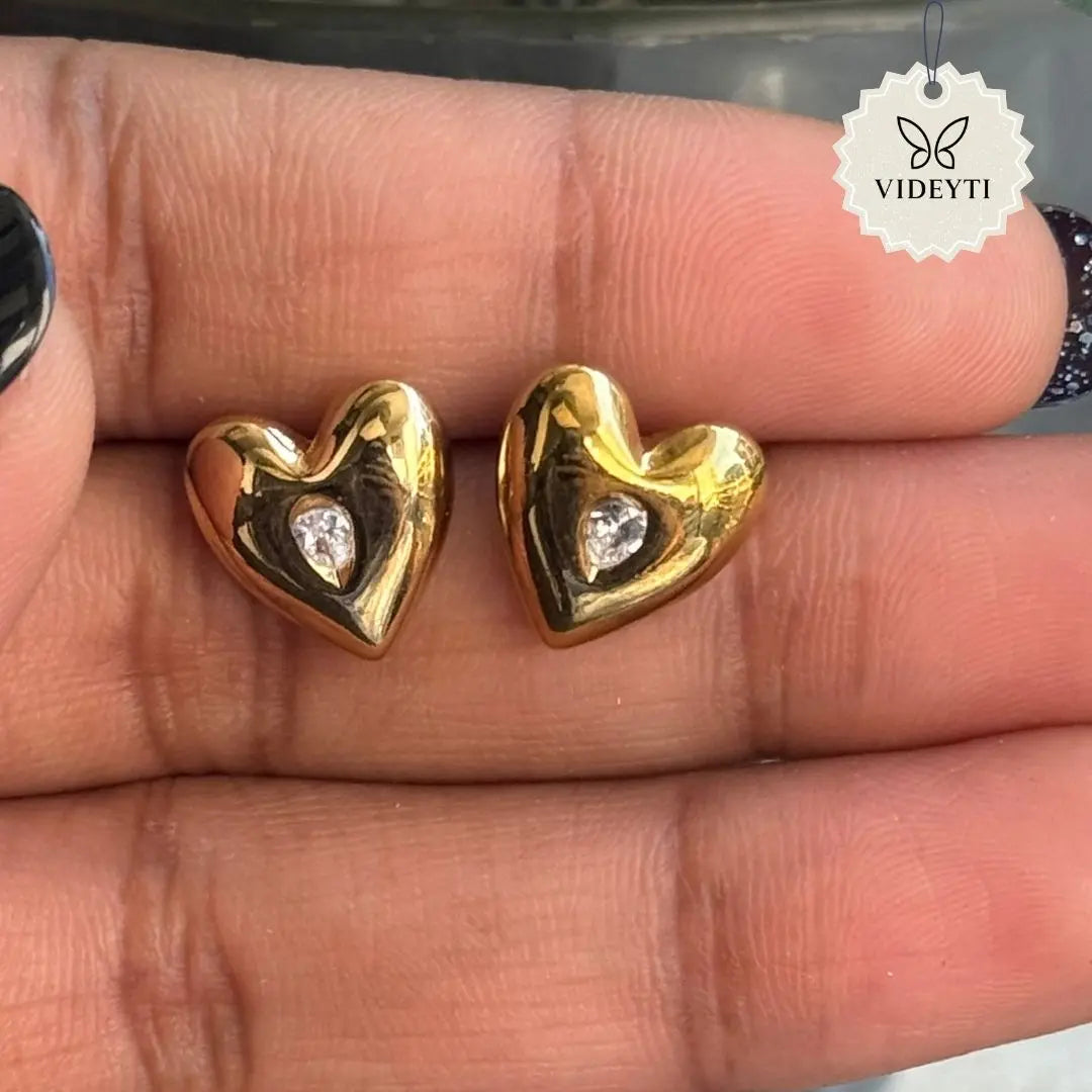 Gold-tone heart stud earrings with clear stone center