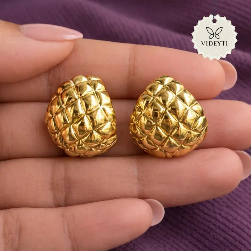 Quilted dome-shaped gold-tone stud earrings with textured finish