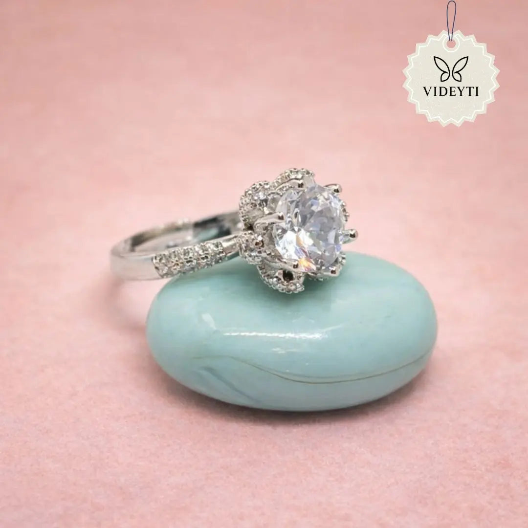 Silver stainless steel solitaire ring with round-cut crystal and pavé band; adjustable anti-tarnish Korean-style jewelry.