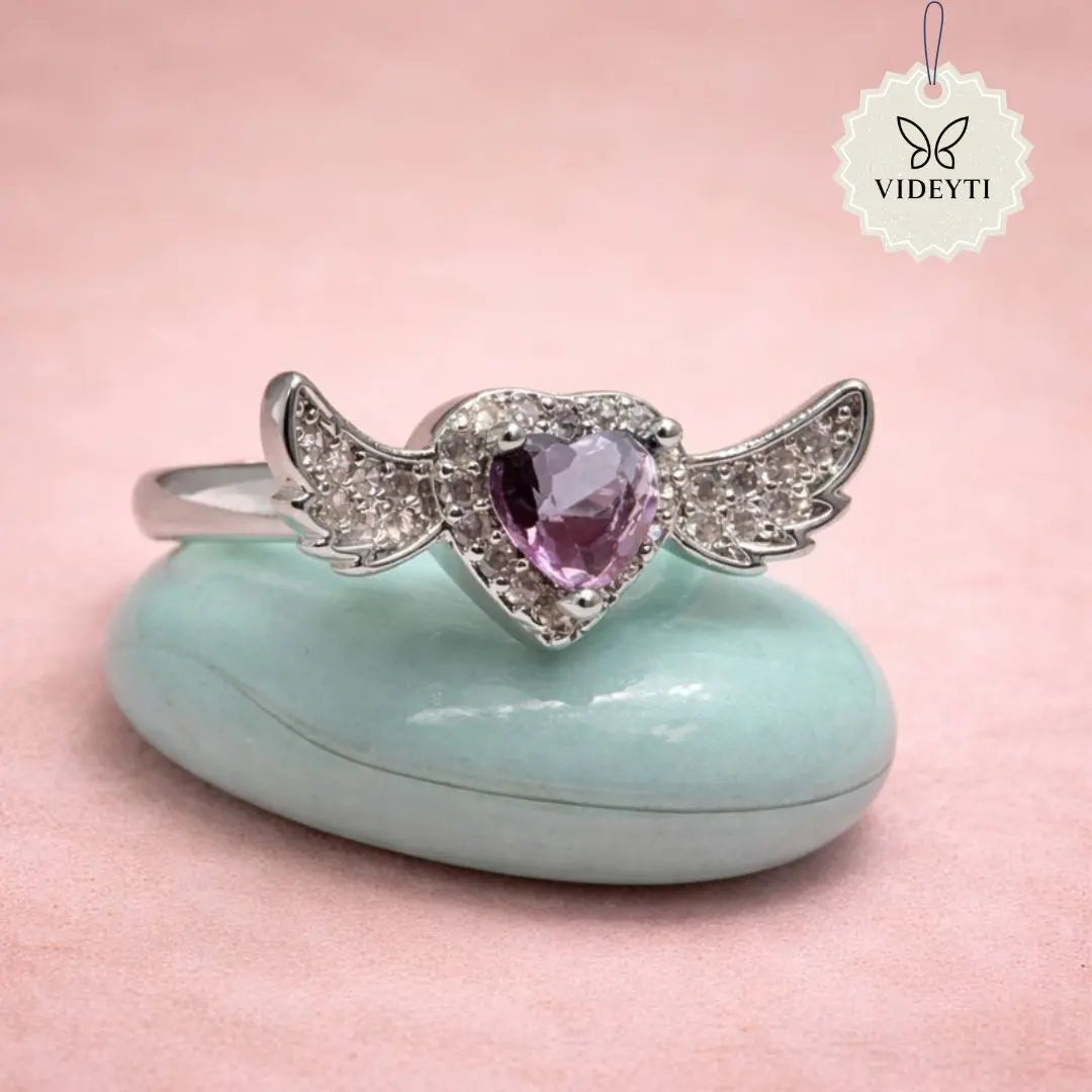 Silver stainless steel ring with heart-shaped crystal and angel wing detailing; adjustable anti-tarnish Korean-style jewelry.