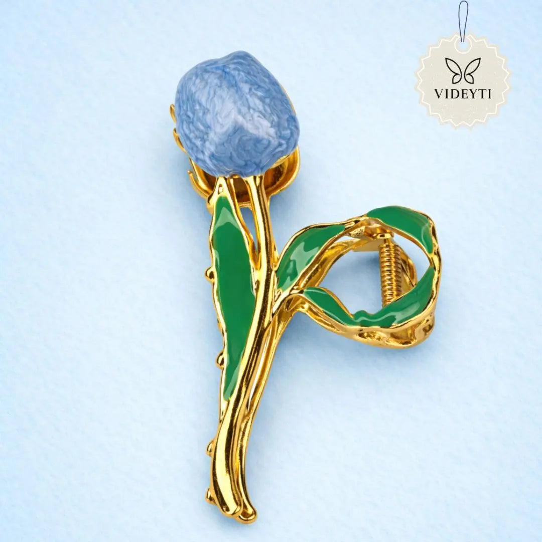 Gold metal hair clip with blue tulip and green leaves