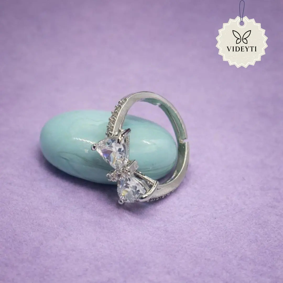 Silver stainless steel ring with dual crystal flower blooms and pavé band; adjustable anti-tarnish Korean-style jewelry.