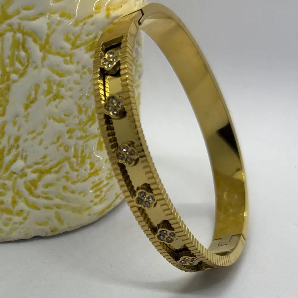 Golden floral accent bangle bracelet for women