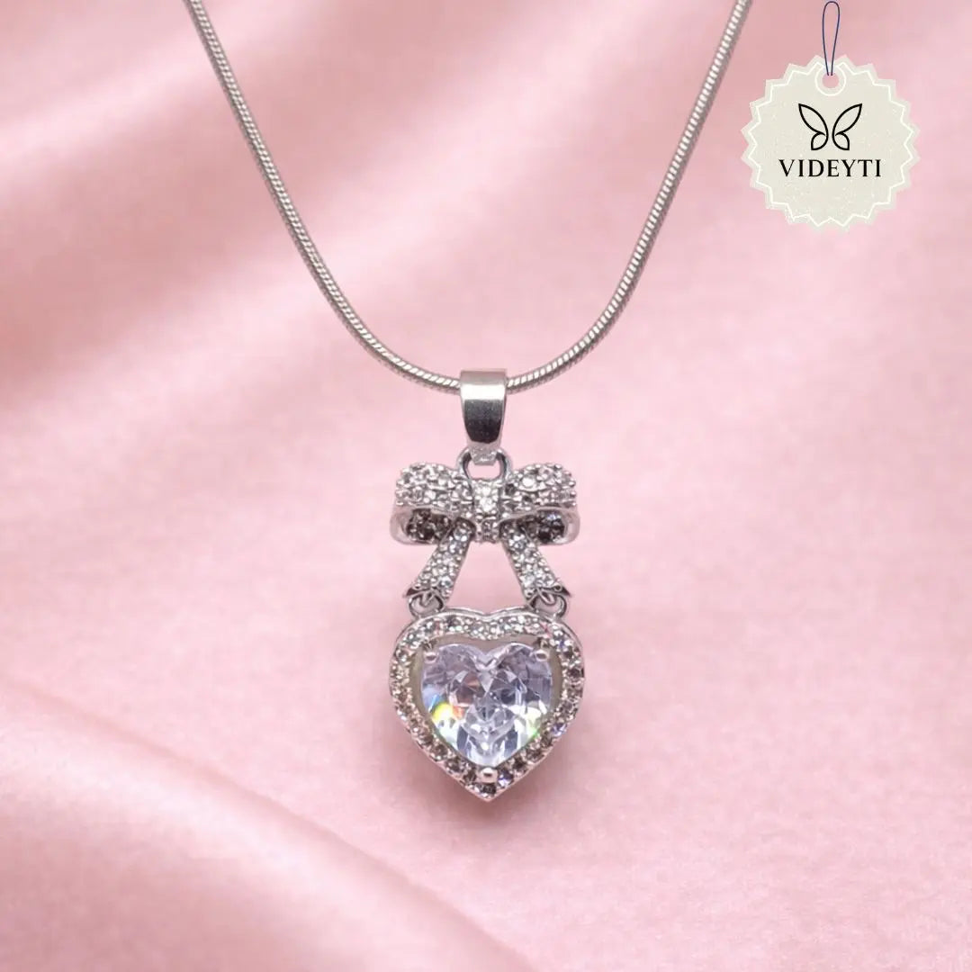 Silver bow heart pendant necklace with crystal detailing