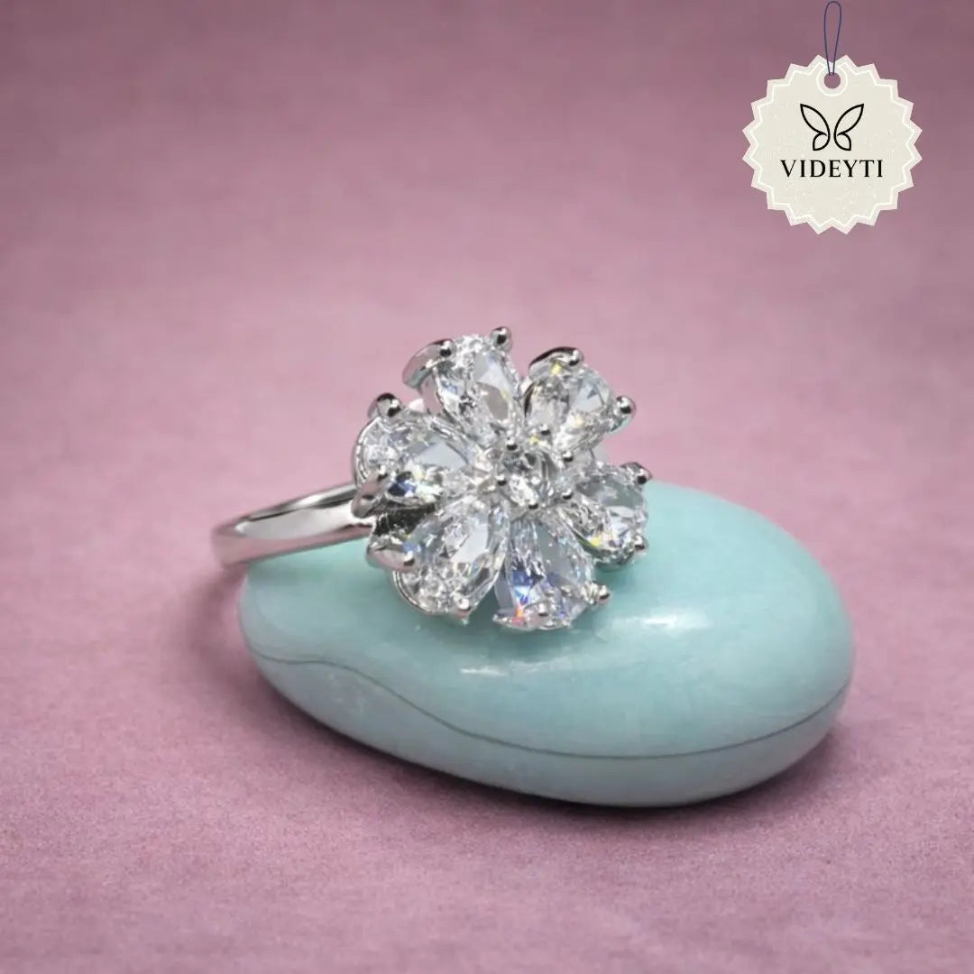 Silver stainless steel floral cluster ring with multiple crystal petals; adjustable anti-tarnish Korean-style jewelry.