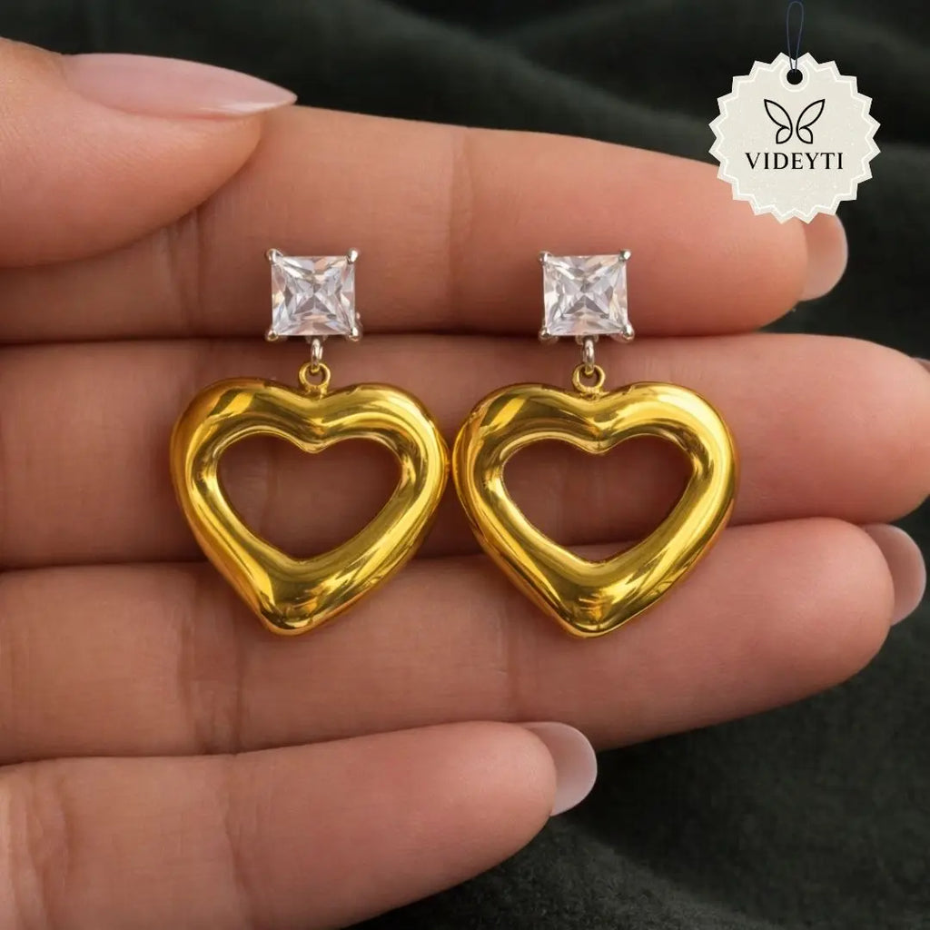 Puffed heart-shaped drop earrings with gold-tone finish and crystal studs